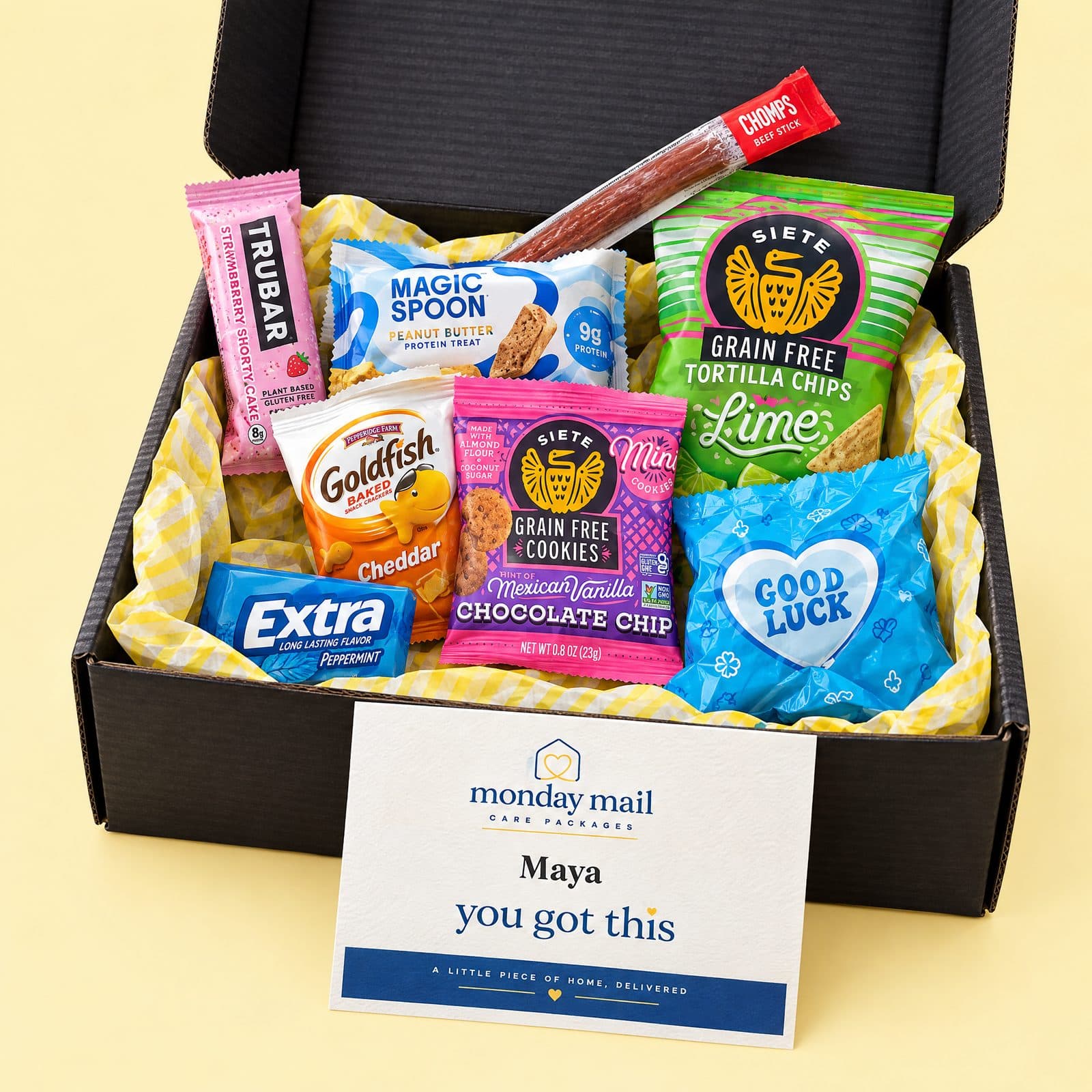 The You've Got This box open on a butter-yellow backdrop with all eight items and a card for Maya